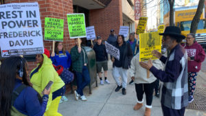 Elder Mmoja Ajabu speaks to a rally outside the Prosecutor's Office
