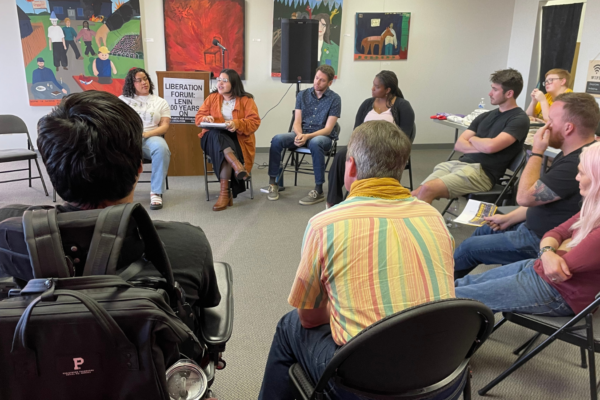 A group of people sitting in a circle, talking.