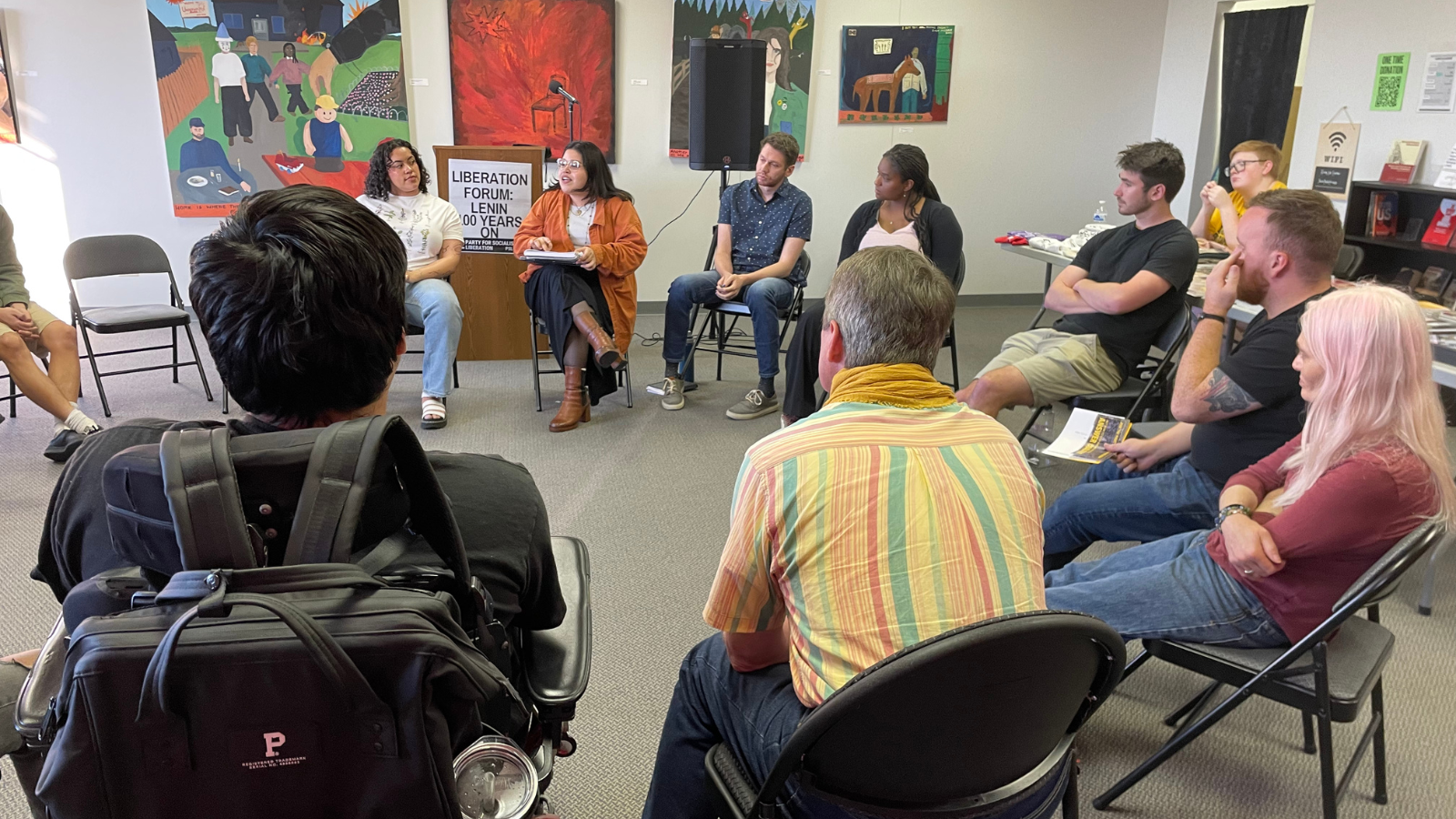 A group of people sitting in a circle, talking.